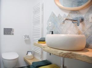 a bathroom with a sink and a toilet at Boutique B&B El Refugio in Alcaucín +36 photos