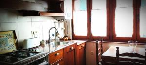 a kitchen with a sink and a stove top oven at As pitas in Tapia de Casariego