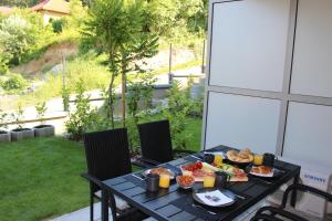 a black table with food on it on a patio at Edison Villa 106 in Fonyód