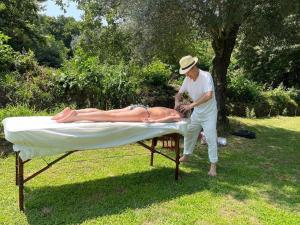 a man is laying on a bed in the grass at Casa de Cerqueda in Celorico de Basto