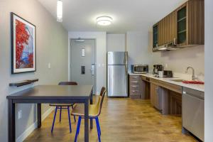 a kitchen with a table and chairs and a refrigerator at Residence Inn Providence Downtown in Providence