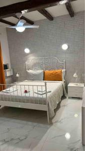 a bedroom with a white bed and a brick wall at CORTICELLA 1 in Bologna