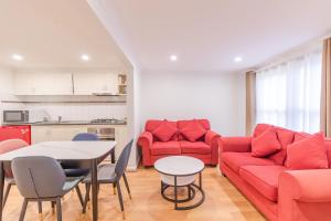 a living room with a red couch and a table at Warburton Lodge in Warburton