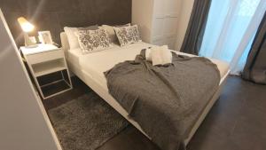 a bedroom with a bed and a table with a lamp at Small and Cozy Rooms - G10 in Valencia