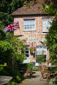 a house with a british flag in front of it at Cottage on The Croft in Hungerford