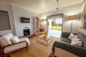 a living room with a couch and a fireplace at Saxenburg Wine Farm in Kuilsrivier