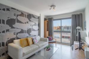 a living room with a couch and a large window at Penthouse Mirador 5B Casasol in Nerja