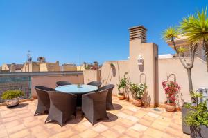a patio with a table and chairs on a roof at Penthouse Mirador 5B Casasol in Nerja