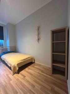 a bedroom with a bed and a book shelf at Apartment Jõesuu in Narva