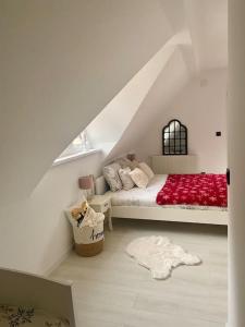 a bedroom with a bed with a red blanket at Farmhouse Dženi in Vlasic