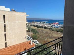 a view of a building with a car parked on a hill at Lavrio 1Bdr penthouse 7 min on foot from the port in Lavrio