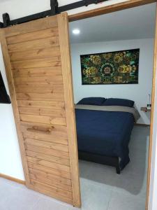 una puerta de madera que conduce a una cama en un dormitorio en Lost Paradise 1 en Hinkong
