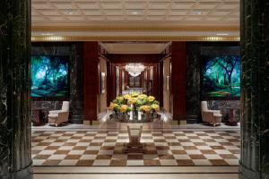 a lobby with a vase of flowers on a table at JW Marriott Essex House New York in New York