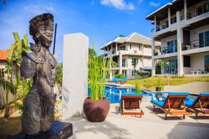 eine Statue vor einem Resort mit Pool in der Unterkunft TROPICA - Villas Resort in Bophut 