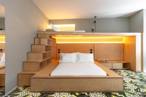a bedroom with a bed and a staircase at Independente Bica in Lisbon