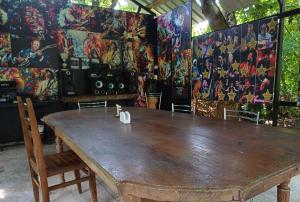 a large wooden table in a room with paintings on the wall at Blues Village in Lagodekhi