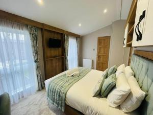 a bedroom with a large bed and a large window at Country Cabin with Hot Tub in York