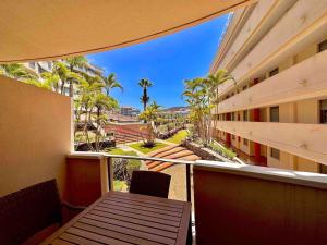 a balcony with a table and chairs in a building at Apartment Amaro, El Palm Mar, Tenerife in Palm-Mar