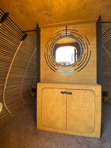 a room with a round mirror and a cabinet at Remote. Forgotten Rivers in Ak-Say