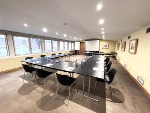 a large conference room with a large table and chairs at 1881 Madrid Ventas Hotel in Madrid