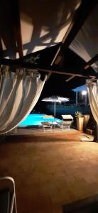 a group of chairs and umbrellas on a patio at Serraiola Alta in Monterotondo