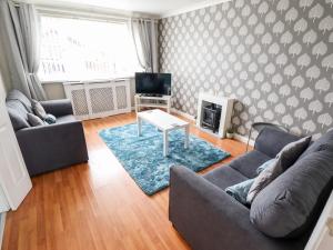 a living room with a couch and a table and a tv at Mariai Eton Road in Mablethorpe