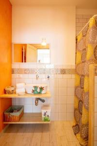 a bathroom with a sink and a mirror at FinisTerrae Rooms and Suites in Gagliano del Capo +28 photos