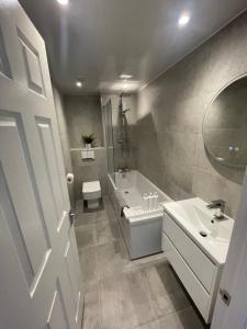 a bathroom with a sink and a toilet and a tub at Glasgow SECC Hydro River View in Glasgow