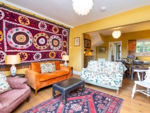 a living room filled with furniture and a rug at Pass the Keys Spacious family home with amazing views in Bath