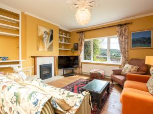 a living room with a couch and a fireplace at Pass the Keys Spacious family home with amazing views in Bath