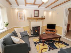 a living room with a couch and a fireplace at 106 Westgate in Guisborough