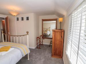 a bedroom with a bed and a dresser and a mirror at 106 Westgate in Guisborough