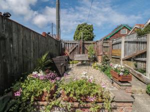 a garden with flowers and a wooden fence at 106 Westgate in Guisborough