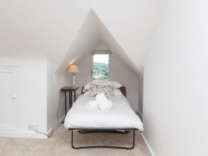 a bedroom with a white bed in a attic at Pass the Keys Spacious family home with amazing views in Bath