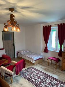 a living room with two beds and a rug at Chalupa Františkov 