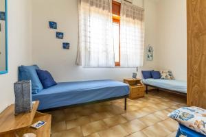 a bedroom with two beds and a window at Villetta Dany by BarbarHouse in Torre Lapillo