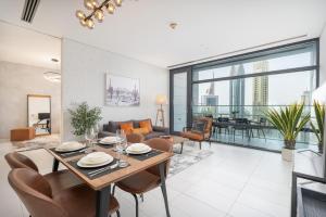 sala de estar con mesa, sillas y sofá en Bright and central Index Tower DIFC by Suiteable, en Dubái