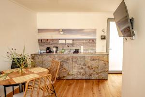 a kitchen and dining room with a table and a counter at DASWEINBERG contactless check-in in Podersdorf am See
