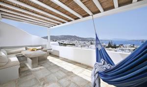 a hammock on a balcony with a view of the city at CASA D'IRENE Mykonian residence in Mikonos