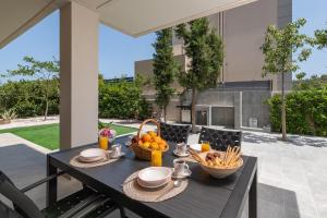 a black table with a bowl of fruit on it at Dioni Pool House in Ialyssos