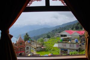 a view of a town from a window at 9 Senses Group hotels , Ravangla in Ravangla