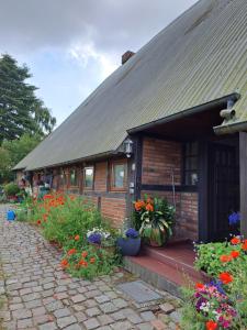 a house with a bunch of flowers in front of it at Ferienwohnung Gitta 