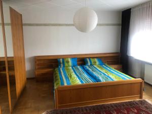 a bedroom with a bed with a wooden head board at Ferienwohnung Moselblick in Nittel