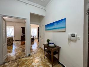 a living room with a table and a picture on the wall at House La Superba by Holiday World in Genova