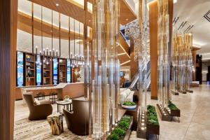 a lobby of a hotel with glass columns at JW Marriott, Anaheim Resort in Anaheim