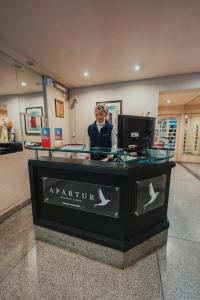 a woman standing behind a counter in a store at Apartur Buenos Aires in Buenos Aires