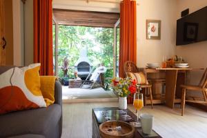 a living room with a couch and a table at Hayne Barn Estate - Luxury Lodges with private hot-tubs- The studio-loft is without hot-tub in Hythe