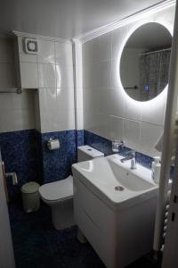 a bathroom with a sink and a toilet and a mirror at Syntagma-Monastiraki bus stop in Athens