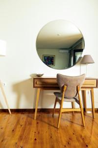 a mirror sitting on top of a desk with a chair at Dohos Hotel in Karítsa