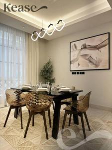 a dining room with a black table and chairs at Kease King Salman T-6 Royal Touch GZ61 in Riyadh